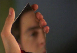 Mike uses a piece of broken mirror to check if Kirsty has been taken or not.